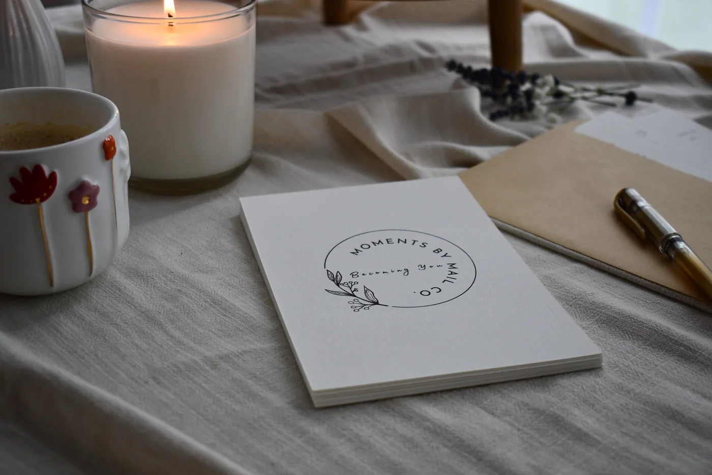 Becoming You cards staged with coffee, candle, envelope, and pen.