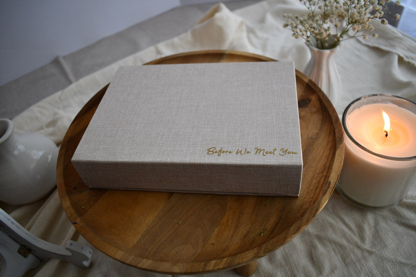 Before We Meet You keepsake box styled with a candle and flowers.