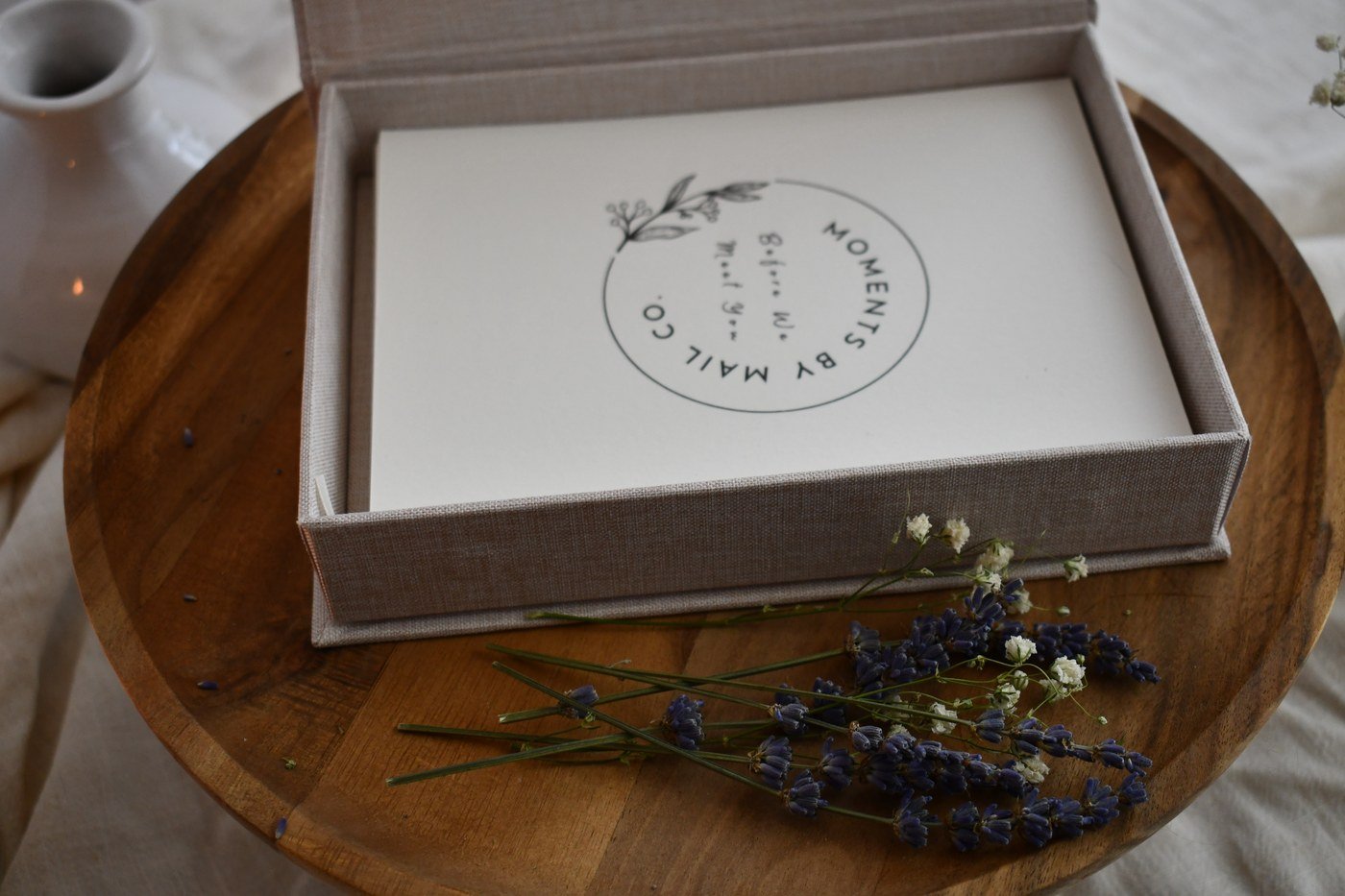 Open Before We Meet You keepsake box with lavender on a wooden table.