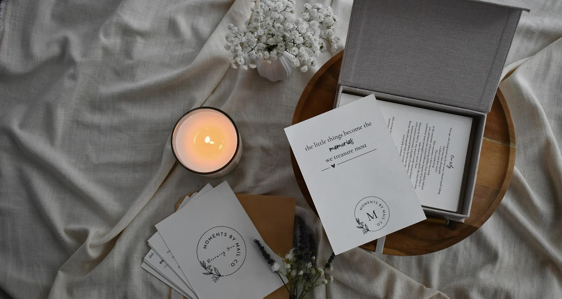 Moments by Mail Co. keepsake cards, memory box, candle, flowers, and handwritten prompt cards.