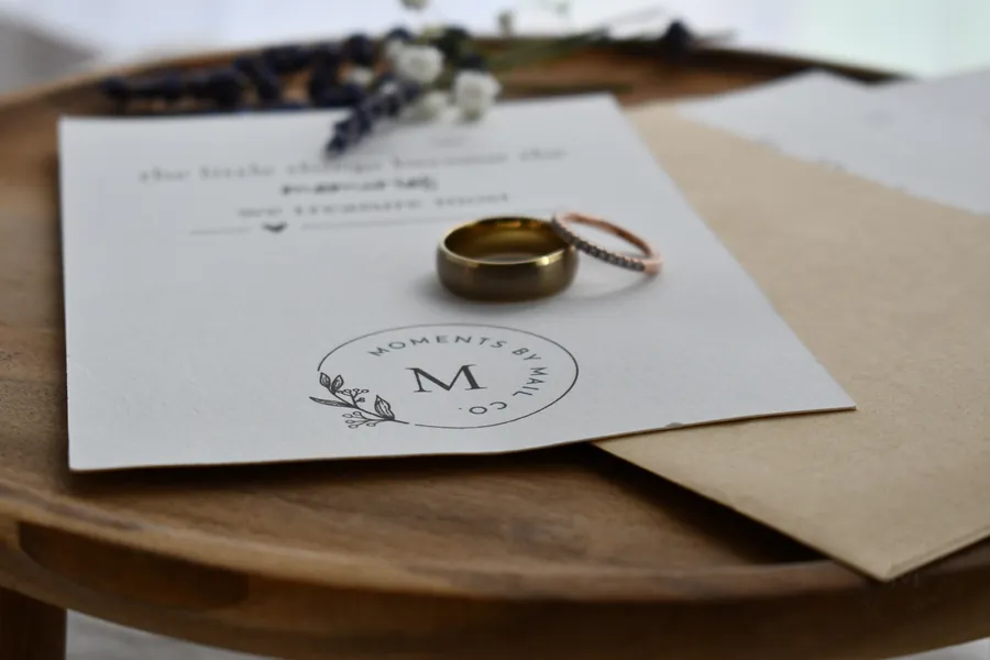 Us, Always keepsake card with wedding rings resting on an envelope.